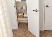 Thumbnail 36 of 37 - A white pantry with a door open to a carpeted floor.