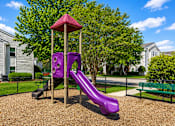 Thumbnail 3 of 18 - A purple slide in a playground with a red roof.