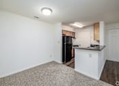 Thumbnail 6 of 20 - A kitchen area with a black refrigerator and a white countertop.