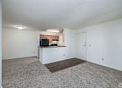 Thumbnail 7 of 20 - A spacious living room with a television and a countertop.