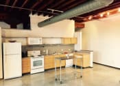 Thumbnail 32 of 34 - an empty kitchen with white appliances and a table
