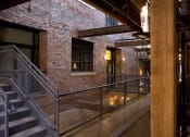 Thumbnail 21 of 34 - the interior of a building with stairs and a brick wall
