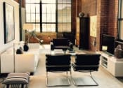 Thumbnail 27 of 34 - a living room with a white couch and a television