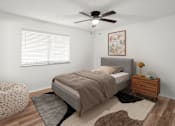 Thumbnail 2 of 14 - A bedroom with a bed, a ceiling fan, and a rug.at Mammoth at the Orchard Apartments, Rogers, AR  