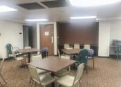 Thumbnail 2 of 10 - a conference room with tables and chairs and a door