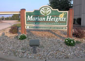 Thumbnail 9 of 10 - a sign for marian heights senior apartment community in front of a building