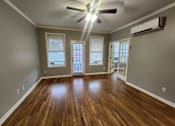 Thumbnail 6 of 13 - A room with wooden floors and a ceiling fan.