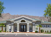 Thumbnail 6 of 6 - the front of a building with palm trees and mountains in the background