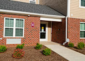 Thumbnail 6 of 15 - A brick building with a sign that says "BAN" on it.
