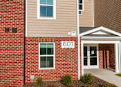 Thumbnail 5 of 15 - A brick building with the number 601 on it.