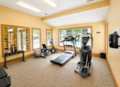 Thumbnail 8 of 9 - A spacious home gym with a variety of exercise equipment.