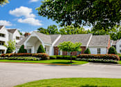 Thumbnail 1 of 9 - A large white house with a grey roof and a green lawn in front.