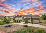 Thumbnail 30 of 32 - A row of houses numbered 4001 are shown in front of a beautiful sunset.