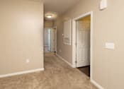 Thumbnail 17 of 18 - a hallway with a door to a bedroom and a closet