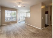 Thumbnail 13 of 18 - an empty living room with a ceiling fan and a window