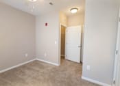 Thumbnail 15 of 18 - a room with a carpeted floor and a door to a closet