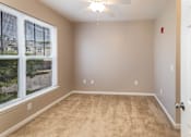 Thumbnail 11 of 18 - an empty living room with a large window and carpet