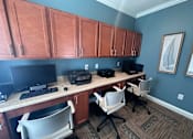 Thumbnail 5 of 18 - an office with two computers and a desk with chairs