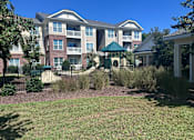 Thumbnail 1 of 18 - an apartment building with a yard and a gazebo