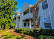 Thumbnail 19 of 20 - A white house with a red brick chimney and a green lawn.