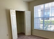 Thumbnail 15 of 26 - A room with a carpeted floor and two open doors.
