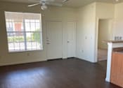 Thumbnail 21 of 26 - A room with a ceiling fan and wooden flooring.