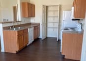 Thumbnail 18 of 26 - A kitchen with wooden cabinets and a white fridge.