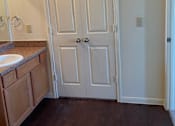 Thumbnail 14 of 26 - A white door with a black handle is in a room with a brown floor.