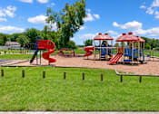 Thumbnail 3 of 4 - A playground with a red slide and a blue slide.