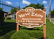 Thumbnail 2 of 4 - A sign for New Zion Apartments with 1, 2, and 3 bedrooms.