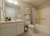 Thumbnail 12 of 47 - A bathroom with a toilet, sink, and bathtub.