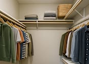 Thumbnail 10 of 47 - A small closet with clothes and shoes.