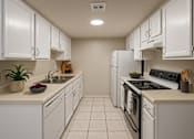 Thumbnail 16 of 47 - A kitchen with white cabinets and appliances.