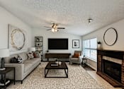 Thumbnail 6 of 47 - A living room with a fireplace and a flat screen TV.