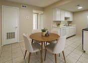 Thumbnail 20 of 47 - A kitchen with a table and chairs in the foreground.