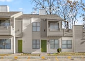 Thumbnail 7 of 28 - A modern two story house with a green door and a balcony. at Osage Creek, Rogers, Arkansas