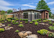 Thumbnail 1 of 14 - A house with a garden in front of it.