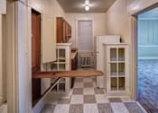 Thumbnail 13 of 15 - A kitchen with a checkered floor and a bench.