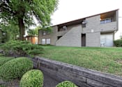 Thumbnail 4 of 15 - A modern house with a grey exterior and a wooden fence in front.