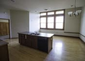 Thumbnail 90 of 100 - A kitchen with wooden floors and a large island.