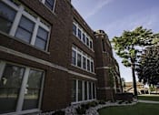 Thumbnail 97 of 100 - A red brick building with white trim and windows.