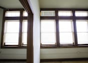 Thumbnail 13 of 100 - A room with two windows and a white wall.
