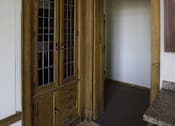 Thumbnail 15 of 100 - A brown wooden door with glass panels and a handle.