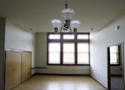 Thumbnail 17 of 100 - A room with a large window and a chandelier hanging from the ceiling.