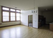 Thumbnail 18 of 100 - A room with wooden floors and a chandelier.