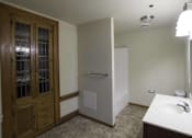 Thumbnail 19 of 100 - A bathroom with a sink, mirror, and a wooden cabinet.