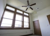 Thumbnail 21 of 100 - A room with a ceiling fan and a window.