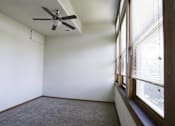 Thumbnail 22 of 100 - A room with a ceiling fan and a window with blinds.