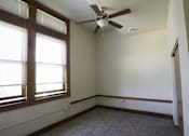 Thumbnail 23 of 100 - A room with a ceiling fan and a window.
