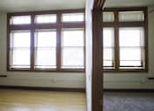 Thumbnail 24 of 100 - A room with two windows and a carpet on the floor.